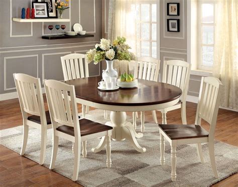 The Vintage White Lanie 7-Piece Cottage Oval Dining Set offers a rustic charm for any dining are ...