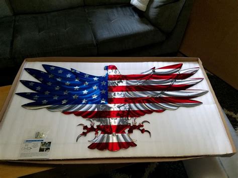 an american eagle with the colors of the flag painted on it's wings is ...