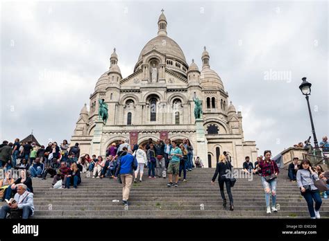 Tourists climbing the stairs of the Sacre Coeur Basilica, famous Landmark at the highest city ...