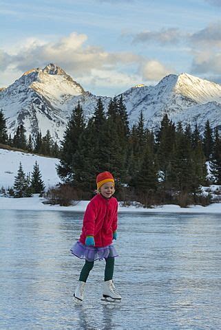 A girl ice skating on early season ice, Molas Lake, San Juan National Forest… Silverton Colorado ...