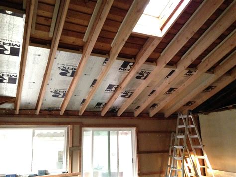 a room that is being remodeled with some wood on the ceiling and ...