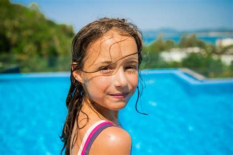 Portrait of Happy Little Girl in Swimming Pool Looking into the Camera ...