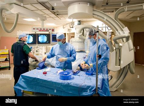 doctors performing angiogram procedure in cardiac cath lab Stock Photo - Alamy