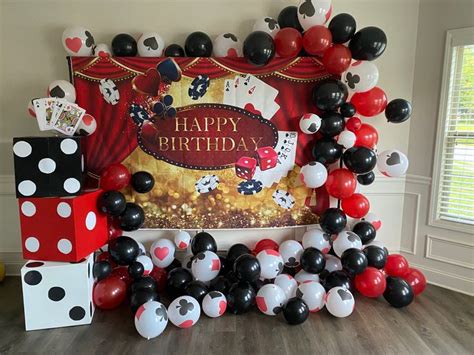 a birthday party with mickey mouse balloons and streamers in the shape ...