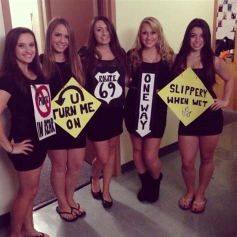 some girls are holding signs and posing for the camera