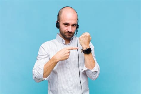 Premium Photo | Man looking impatient and angry, pointing at watch, asking for punctuality