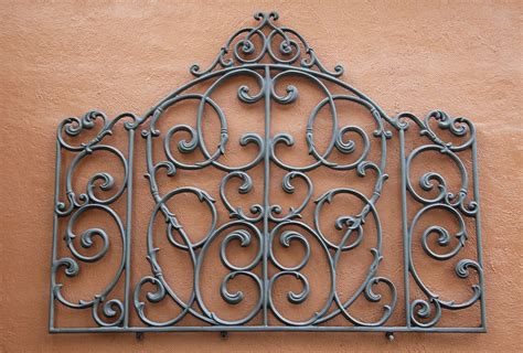 A decorative raw iron embellishment on a texturized wall. | Wrought iron design, Wrought iron ...