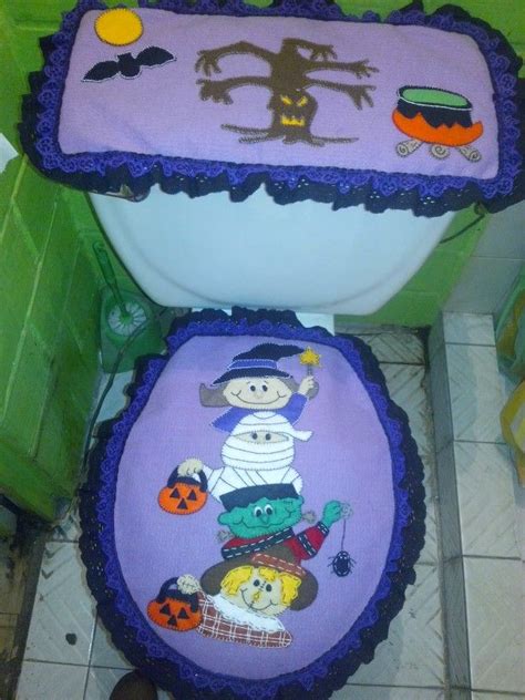 the toilet seat covers are decorated with cartoon characters and pumpkins on purple, blue, and green