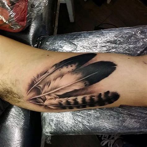 Top 101 Inner Bicep Tattoo Ideas - [2021 Inspiration Guide] | Indian feather tattoos, Inner ...