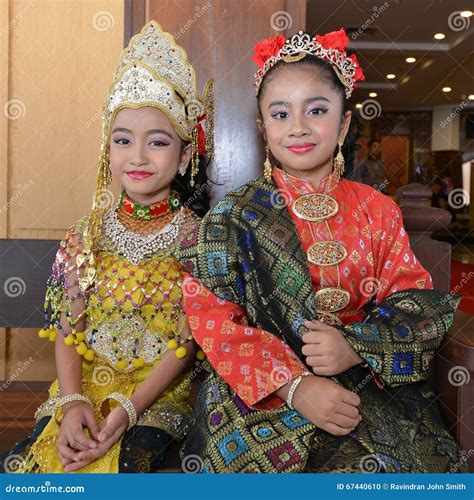 A Young Malay Female Children Ride A Bicycle At Their Hometown. Smile Face From Them. View A ...