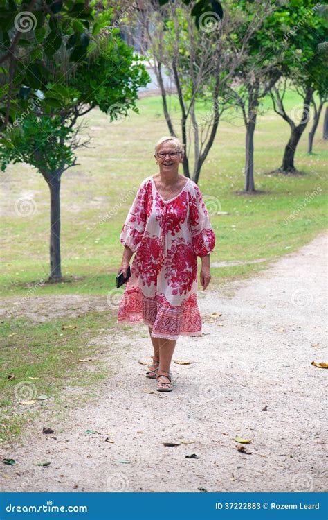 Mature Woman Walking in Park Stock Image - Image of glasses, natural: 37222883