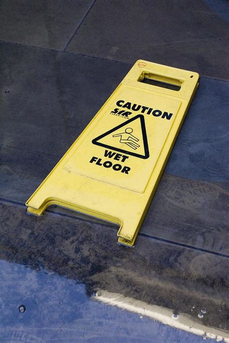 Wet Floor Sign In Puddle Photograph by Mark Williamson - Pixels