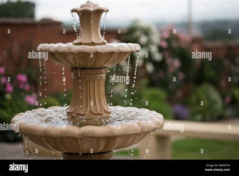 garden fountain with trickling water Stock Photo - Alamy