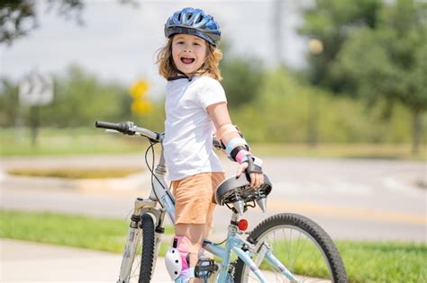 Premium Photo | Kid riding bike in a helmet child with a childs bike ...