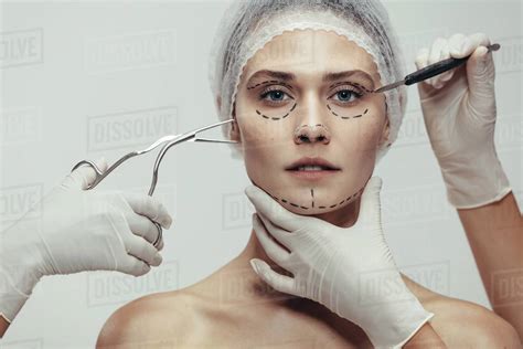 Close up of woman having cosmetic face surgery with scalpel and medical ...