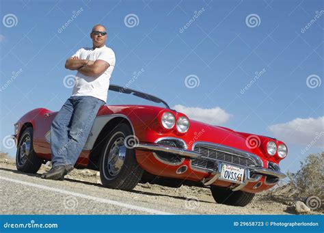 Man Standing Beside Classic Car On Road Stock Photos - Image: 29658723