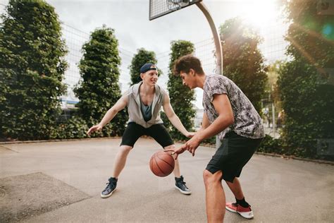 Teenagers playing basketball on outdoor court stock photo (124209 ...