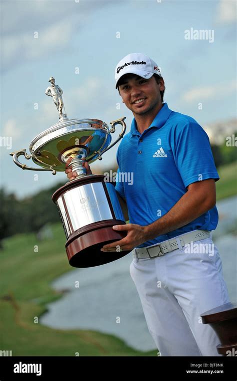 Jason Day celebrates his first US PGA Tour win while holding the trophy ...