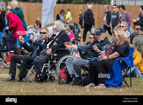 A group of veterans sat together at a world war two commemoration Stock ...