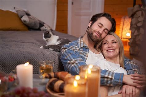 Happy Couple Hugging on Floor Near Bed with Cat Stock Photo - Image of dinner, lady: 237976988