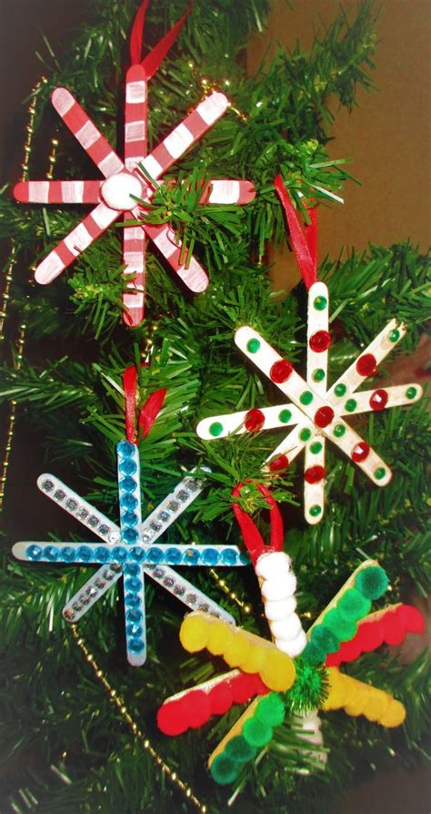 an ornament made out of popsicle sticks is hanging from a christmas tree