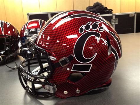 two football helmets sitting on top of a table