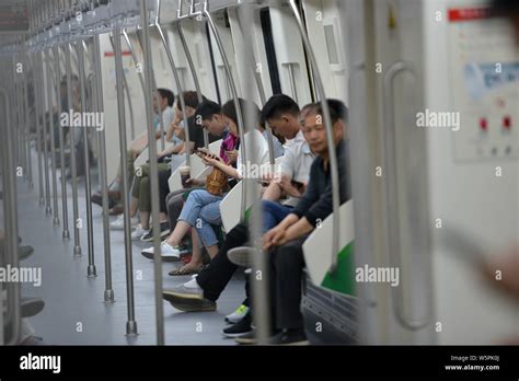 Passengers take a subway train on the Zhengzhou Metro Line 5 enabled ...