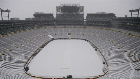 Snow descends upon Lambeau Field