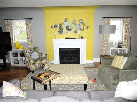 a living room with yellow walls and gray furniture