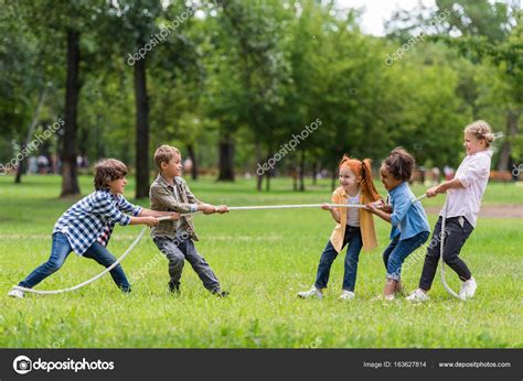 Kids playing tug of war Stock Photo by ©ArturVerkhovetskiy 163627814