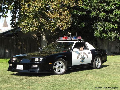 a police car is parked in the grass