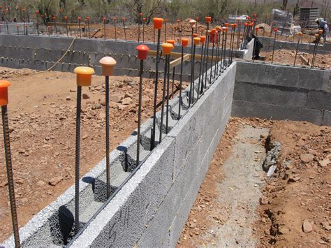 there are many candles lined up on the side of this building that is under construction