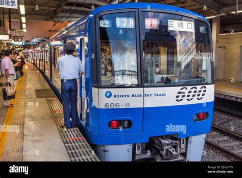 Keikyu Line train to Haneda Airport boards at station Stock Photo - Alamy