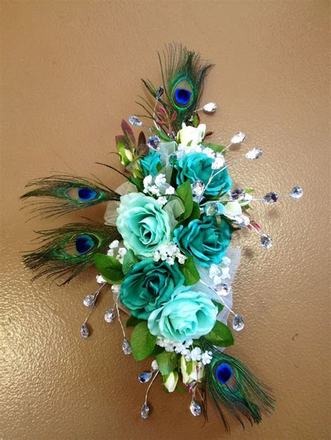 a bouquet of flowers and peacock feathers on a wall