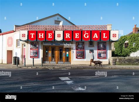 A man and his dogs walking past the colourful exterior of the historic ...