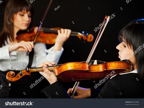 Two Beautiful Female Violinists Playing Violin Isolated On Black Stock Photo 50918089 : Shutterstock