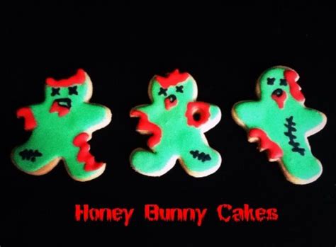 three decorated cookies with green and red icing on a black background that says honey bunny cakes