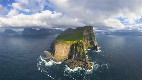 Aerial panorama of Kallur lighthouse and cliffs, Kalsoy island, Faroe ...