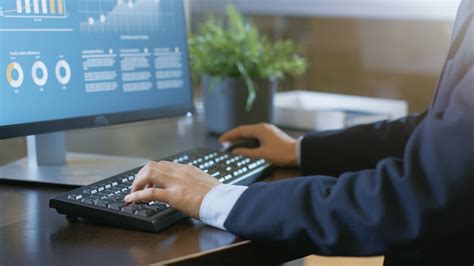 Close-up Businessman's Hands Typing on Keyboard, Desktop Computer Monitor Shows Stock Footage # ...