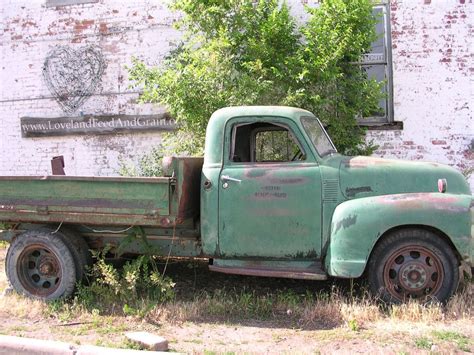 Old truck in front of the Feed & Grain in Loveland, CO | Old trucks, Cool trucks, Farm trucks