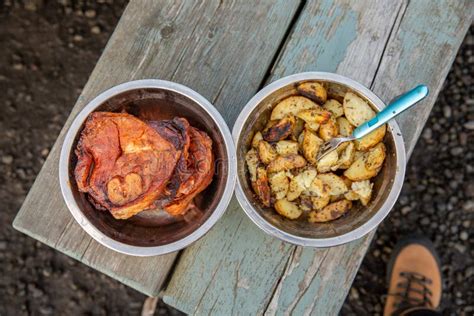 Metal Bowls with Lamb Steaks and Potatoes on Wooden Picnic Table. Top View Stock Photo - Image ...