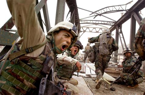 US Marine Corps engineers attempt to make a partially destroyed bridge ...