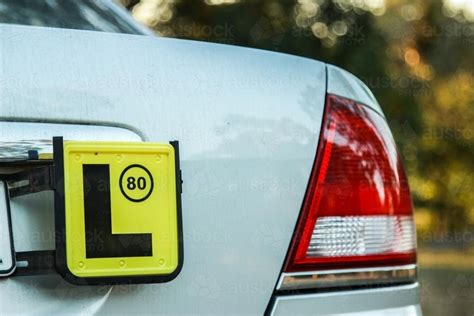 Image of L license plate on the back of a car parked outside - Austockphoto