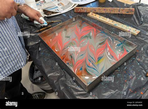 Artist Tugay Yalcin teaches beginners the art of paper marbling, a Turkish discipline known as ...