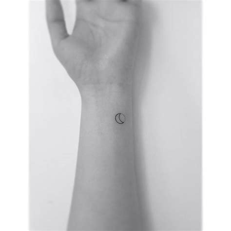 Tiny crescent moon tattoo done on the wrist,