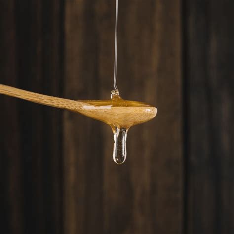 Download Close-up Of Honey Dripping From Wooden Spoon for free in 2020 ...