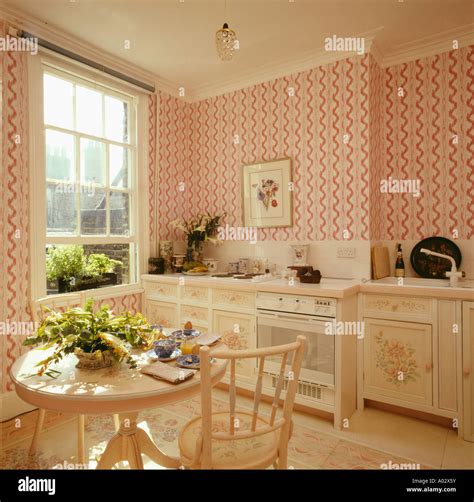 Pink striped wallpaper in Eighties kitchen diningroom with open window ...