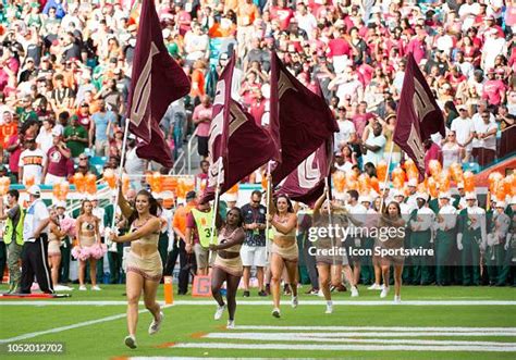 Florida State Seminoles cheerleaders run onto the field with FSU ...