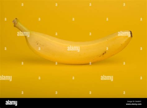 Banana on a yellow background Stock Photo - Alamy