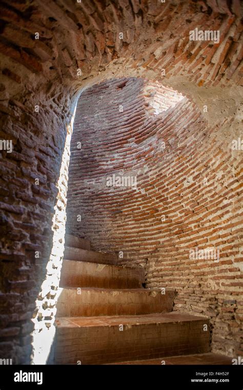 Red brick steps spiral upward inside the Bell Tower of Bantay, ruins of a Spanish church in the ...